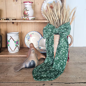 Handmade festive bow with brass ring and velvet ribbon.
