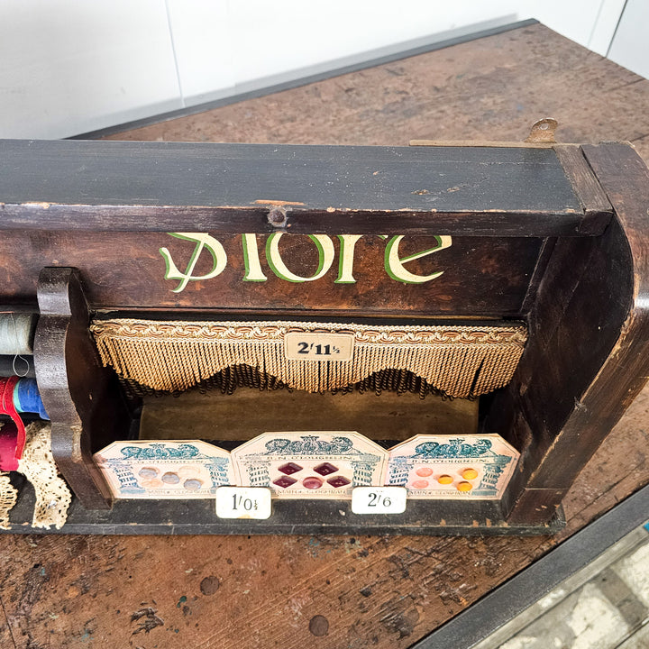 Vintage shop counter display with lace, thread and fringing
