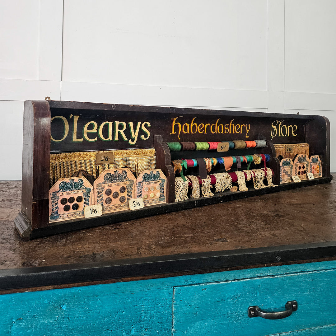 O’Leary’s haberdashery advertising display in wooden frame
