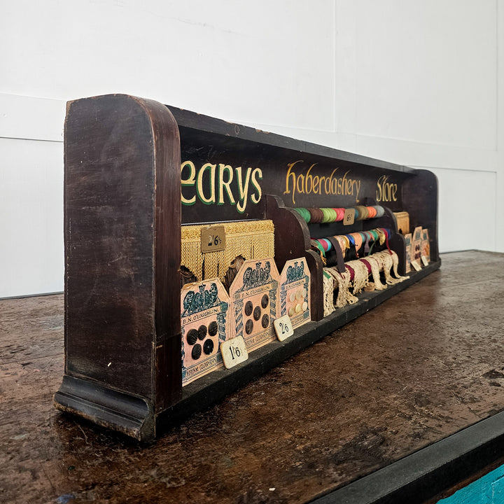 Antique haberdashery board with labelled trims
