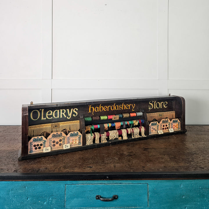 Irish haberdashery shop display with trims and painted lettering
