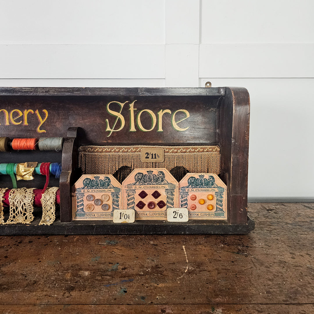 Framed haberdashery samples with early 20th century pricing
