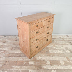 A country style Victorian pine chest of drawers with five drawers in graduating depths and decorative brass handles. The stripped pine finish makes this five drawer storage chest suitable for use in a bedroom or hallway.