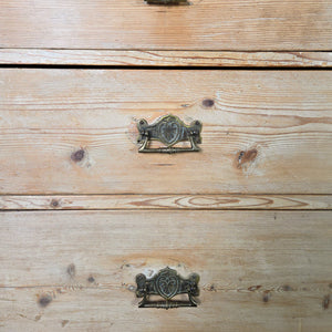 A rustic country pine chest of drawers from the 19th century with five drawers of graduating depth. Finished in stripped pine, this storage chest can be used in a bedroom or as a sideboard for additional storage.