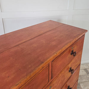 Victorian antique pine chest of drawers finished in a striking red paint with five drawers, arranged two over three. Fitted with wooden knobs and standing on chunky bun feet. A versatile antique piece for farmhouse bedrooms, kitchens, hallways or living rooms.