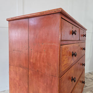Antique painted pine chest of drawers, Victorian period, with five drawers in two over three arrangement. Retains original wooden knobs and red painted surface, raised on bun feet. A fine piece of antique storage furniture for traditional or rustic interiors.