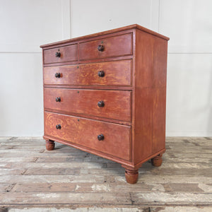 A large Victorian painted pine chest of drawers with five drawers in a two over three arrangement. Finished in original red paintwork, fitted with wooden knobs and raised on chunky bun feet. A striking antique storage piece for bedroom, hallway, living room or farmhouse interior.