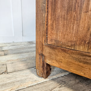 A substantial early 20th-century antique pine chest with a lift-up hinged lid, two internal divided compartments and block feet. The waxed pine finish highlights its rustic grain and farmhouse style appearance, creating a robust wooden blanket box with practical, generous storage for linens and household essentials.