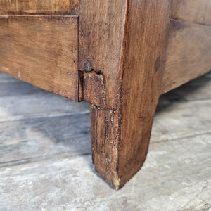 An antique pine blanket box from the early 20th century, offering a hinged lid, two internal storage sections and decorative panelled sides. The waxed pine surface enhances its natural tone and gives the piece a country, cottage style character, making it a solid wooden storage chest with ample room for linens and household items.
