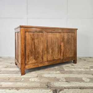 A large antique pine blanket chest from the early 20th century, featuring a hinged lid, two internal sections and simple block feet. The waxed finish enhances the natural grain and warm pine tone, giving this wooden storage trunk a cottage and farmhouse feel with practical divided storage for linens or household items.