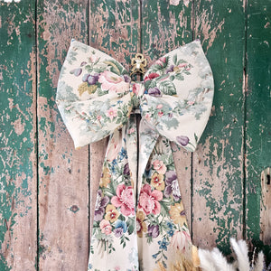 Handcrafted bow from vintage fabric, showcasing a lush floral design