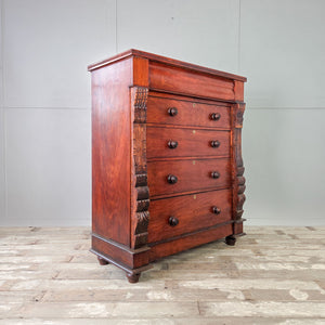 Tall bedroom dresser in warm walnut timber with original handles and decorative side columns.
