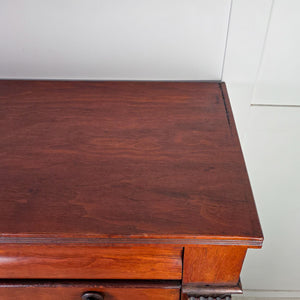 Antique five-drawer walnut dresser with brass diamond keyhole covers and turned wood knobs.
