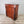 Large bedroom chest of drawers in solid walnut with traditional hand-carved pillar details.
