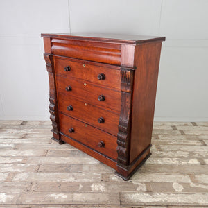 Large bedroom chest of drawers in solid walnut with traditional hand-carved pillar details.
