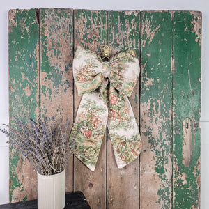 Large decorative bow with romantic countryside scene
