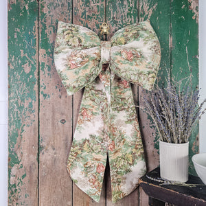 Handmade fabric bow with pastoral toile pattern


