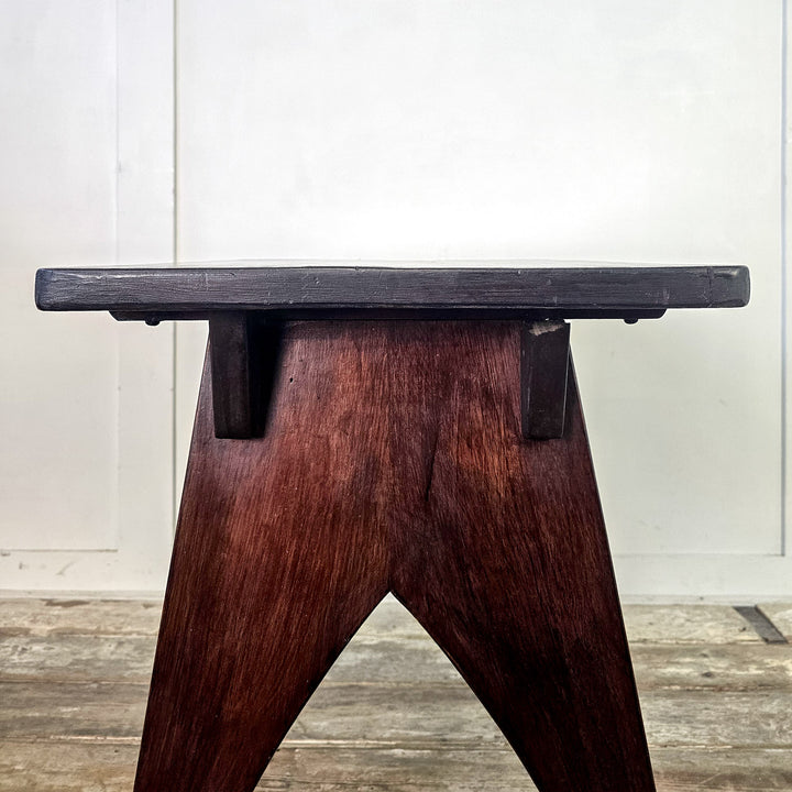 "Mahogany side table with arched base and rectangular top."
