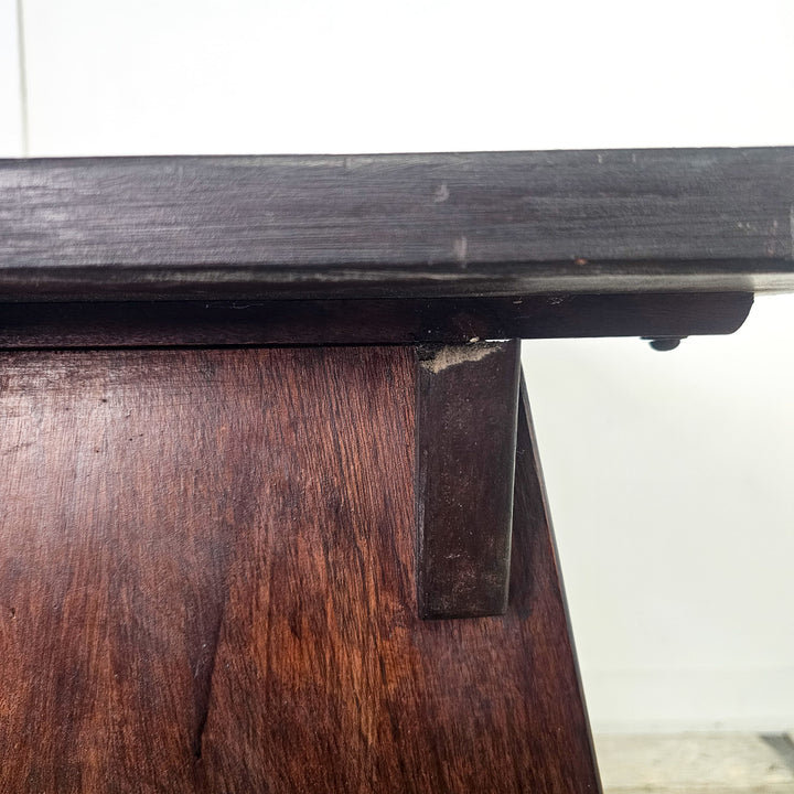 "Stylish mahogany side table with unique arched legs."
