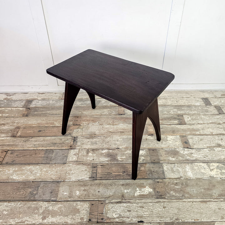 "Sleek side table with rounded rectangular mahogany top."
