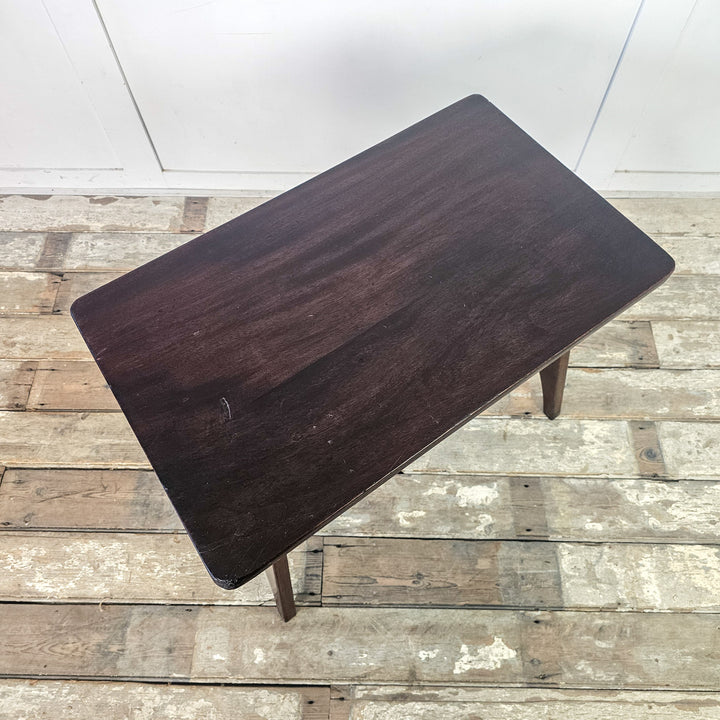 "Rectangular top mahogany table with cut-out base."
