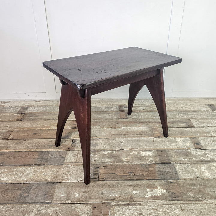 "Rectangular top mahogany table with cut-out base."

