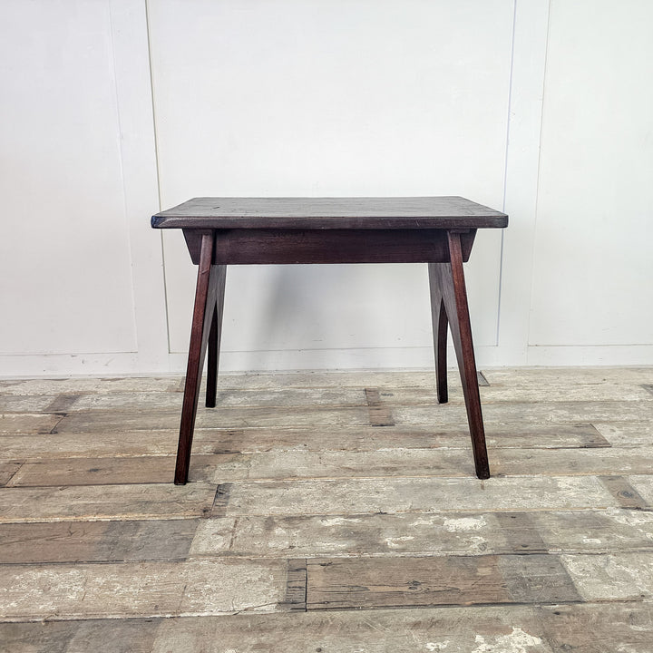 "Elegant mahogany side table with sleek arched support."
