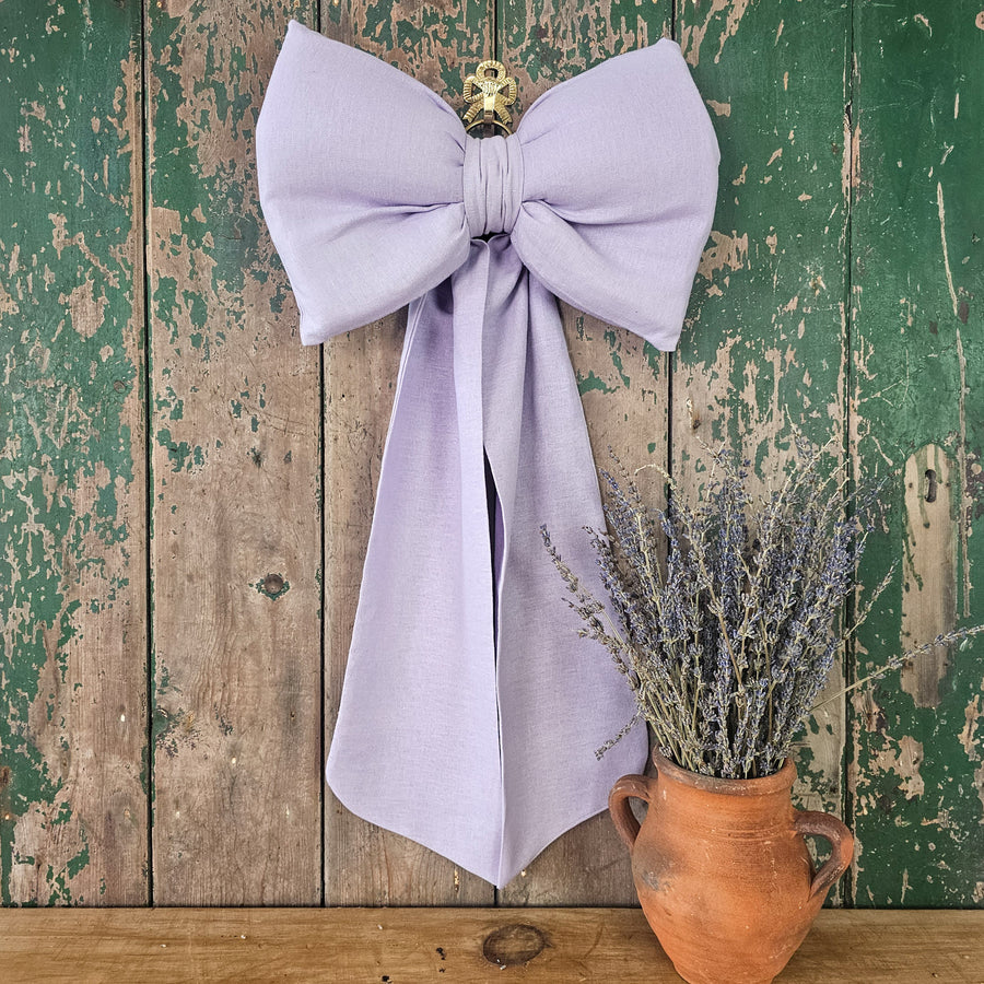 Handmade lilac fabric bow with classic country house styling.
