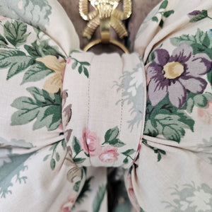 Vintage bow with colorful floral pattern, ideal for rustic home decor."