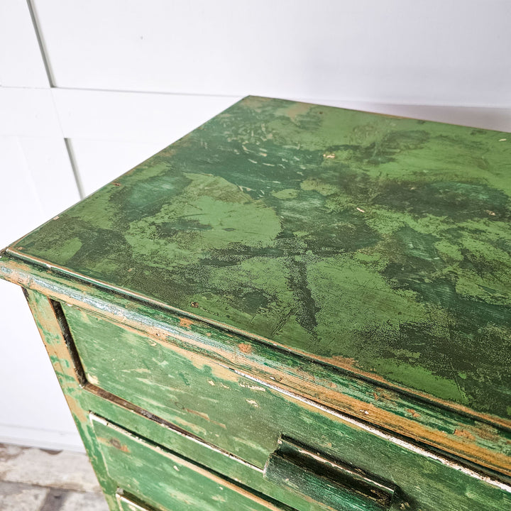 Vintage 1930's cabinet with green painted finish, featuring eight drawers and wooden handles.