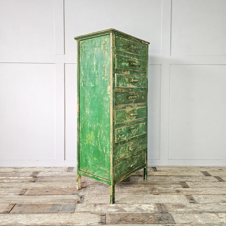 Mid-century style storage solution: pine cabinet with original green paint, raised on straight legs.