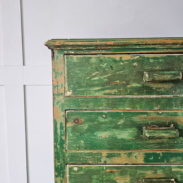 Pine cabinet from the 1930s boasting a vibrant green paint finish and ample storage space in its eight drawers