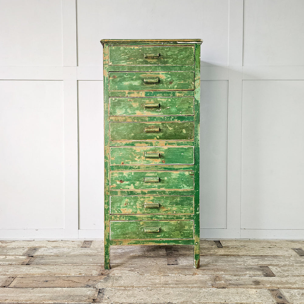 Mid-century storage solution: A pine cabinet from the 1930s with original green finish, featuring wooden drawer handles and raised on straight legs.