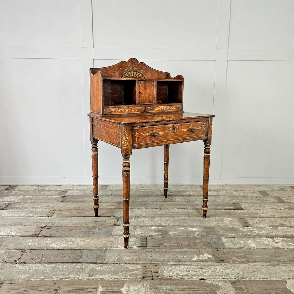 19th century antique desk with decorative overpaint and brass drawer knobs
