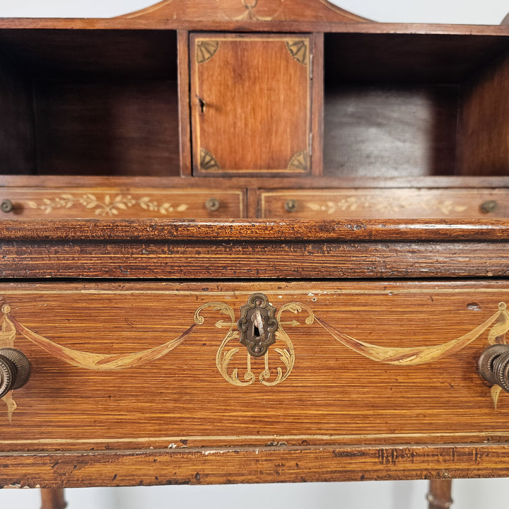 Compact writing desk with decorative painted gallery and pine base

