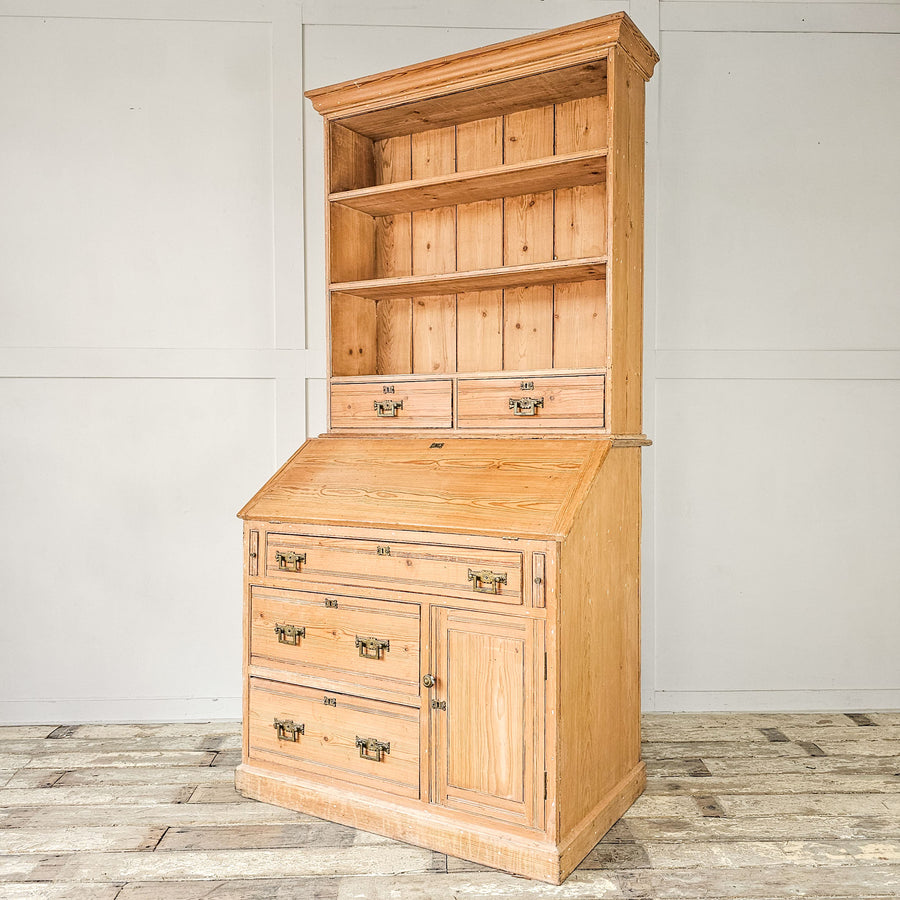Vintage pine bureau bookcase with open shelving and drawers.