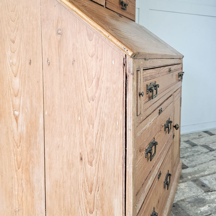 Pine cabinet with open shelving and storage drawers.