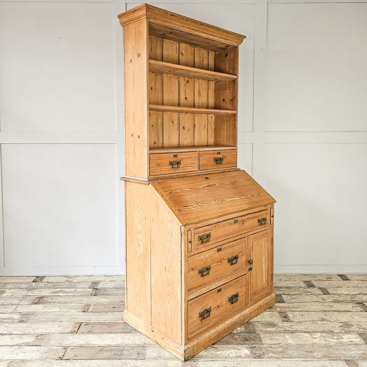 Antique pine cabinet with storage drawers.