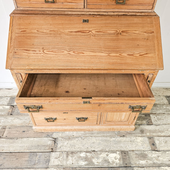 Antique pine bureau with rustic charm and ample storage.