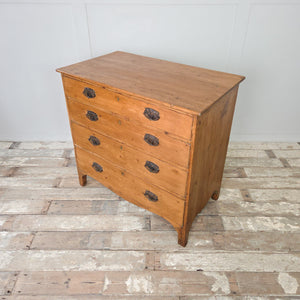 Georgian pine chest of drawers dating to the early 19th century, with four graduating drawers, brass plate drop handles and ogee style feet, sealed in a rustic pine wax.