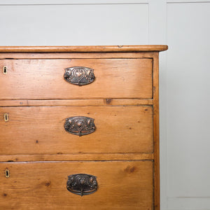 Early 19th century Georgian pine chest of drawers, showing four full-width drawers with brass plate drop handles and a shaped apron raised on ogee style feet.