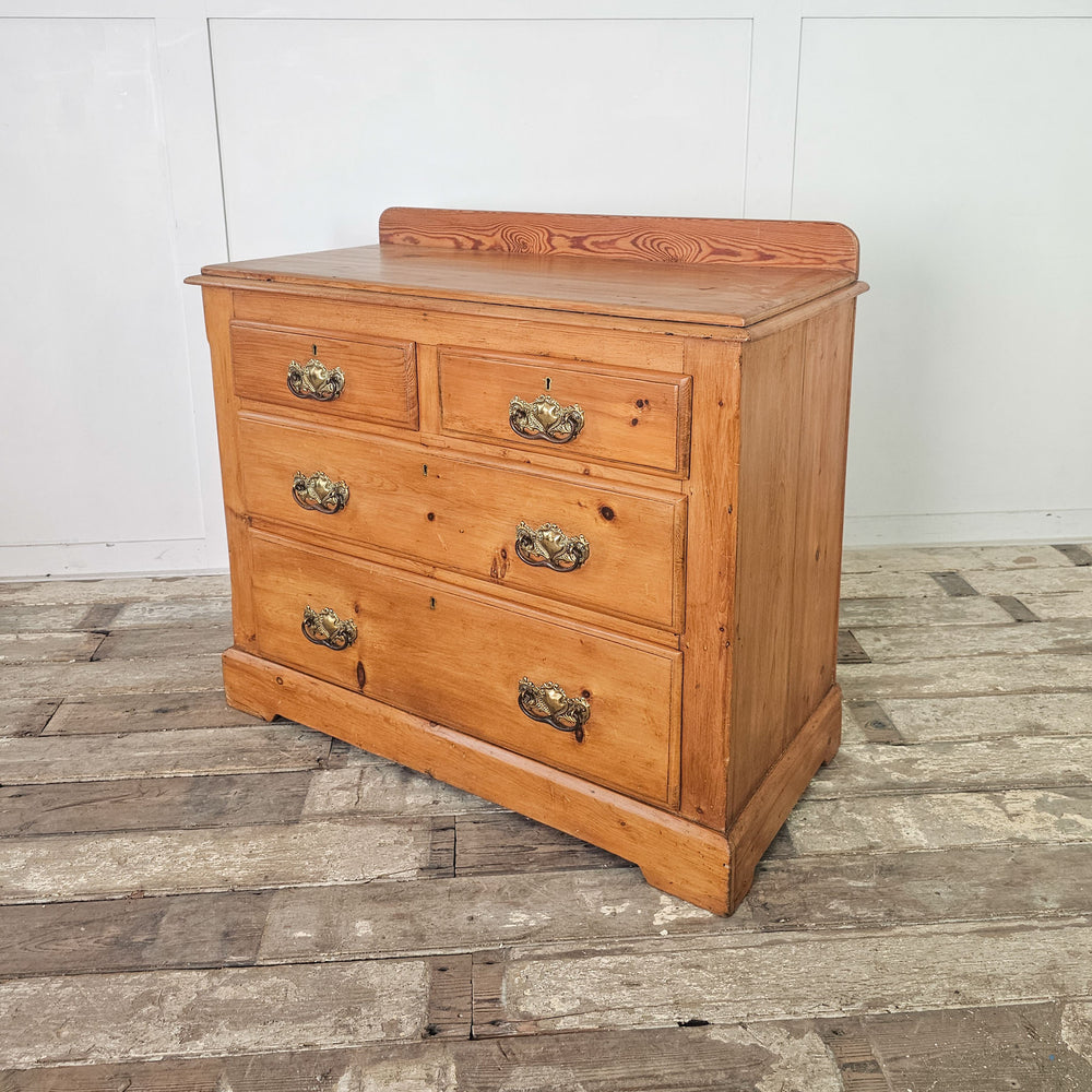Antique pine chest with four drawers, two over two arrangement.

