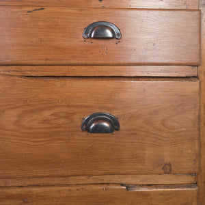 Early 20th century pine chest of drawers featuring four generously sized drawers, fitted with cup handles added at a later date, and standing on a simple plinth base.

