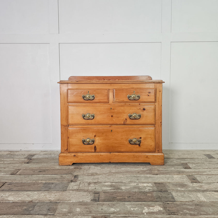 Early 20th-century pine chest of drawers with original hardware.
