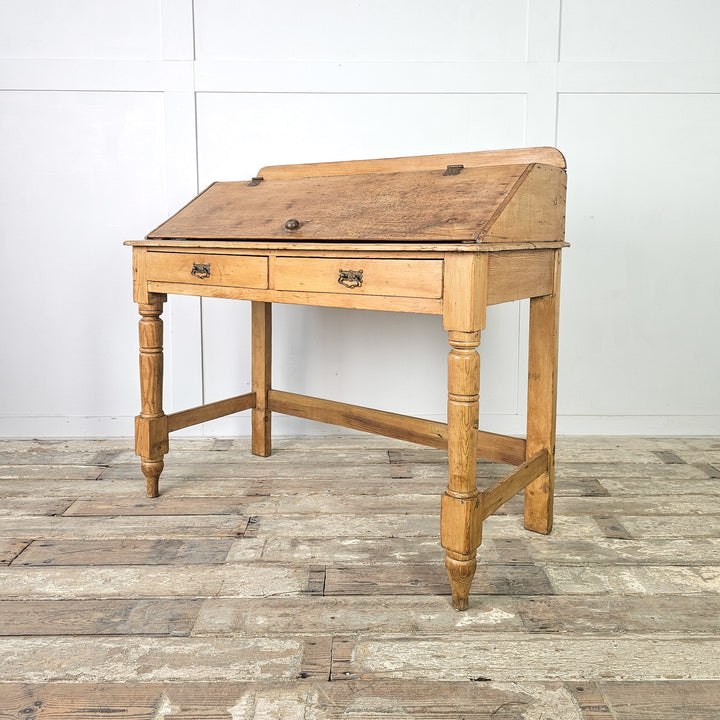 Victorian pine desk with sloped hinged lid and two drawers
