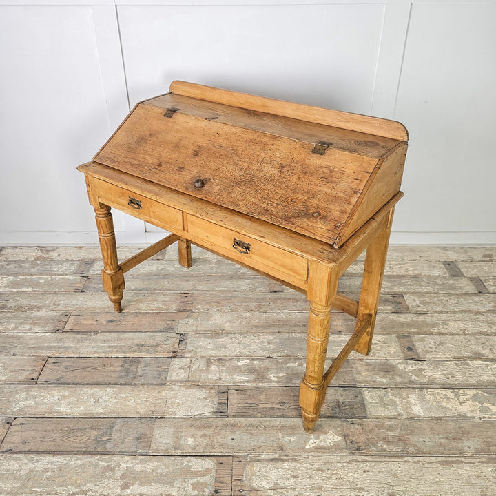 Victorian pine writing desk with two drawers and upright lid
