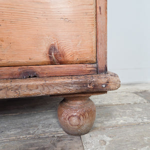 A Victorian pine dresser base with central open shelving and seven graduated drawers. The layout works well for kitchen storage or for use as a sideboard along a wall in a living room.