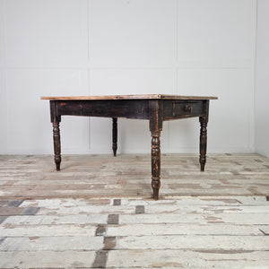 A 19th century farmhouse table with a broad rectangular hardwood top, most likely beech, raised on four turned legs. The base retains its original black painted finish, while the pale, honey-toned planked top contrasts clearly and is finished with a moulded edge.