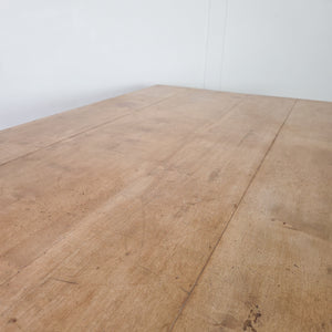 A 19th century farmhouse table with a broad rectangular planked hardwood top, most likely beech, raised on four turned legs. The base retains its original black painted finish and includes two drawers, one at each end, making it suitable for use as a kitchen or dining table.