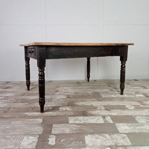 This large 19th century farmhouse table is built with a broad hardwood top, most likely beech, and a painted base with turned legs. The two drawers at each end offer useful storage, making it a practical kitchen table or dining table.